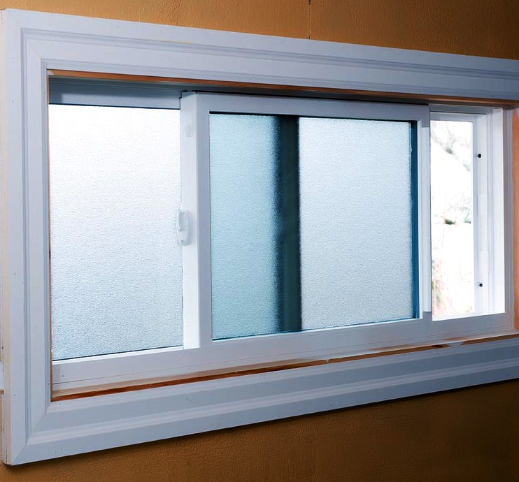 Kohltech obscured glass glider window in the basement of a house
